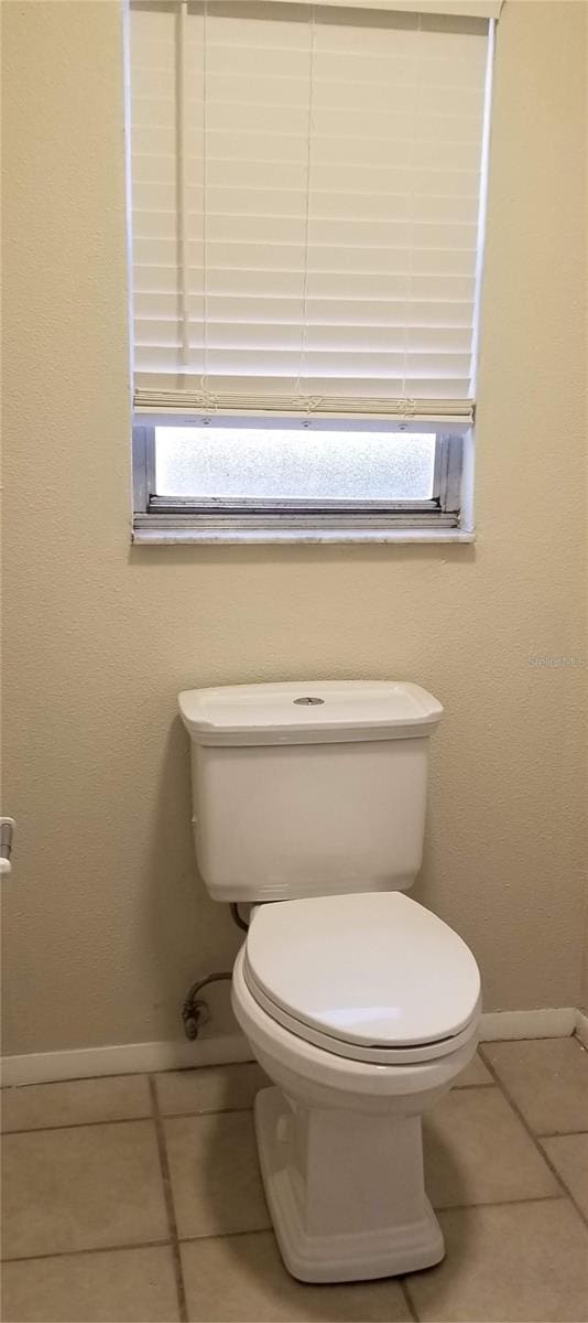 1841 Georgia Ave, Palm Harbor, FL 34683 - bathroom featuring baseboards, toilet, and tile patterned flooring