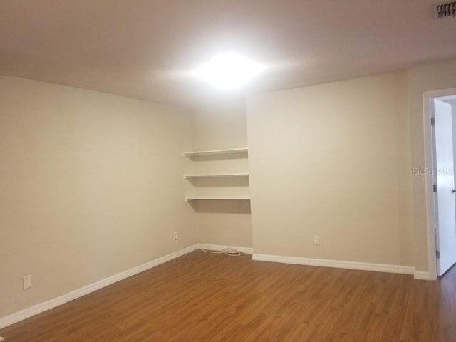 1841 Georgia Ave, Palm Harbor, FL 34683 - unfurnished room featuring wood finished floors and baseboards