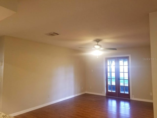 1841 Georgia Ave, Palm Harbor, FL 34683 - empty room featuring french doors, dark wood-style floors, baseboards, and a ceiling fan