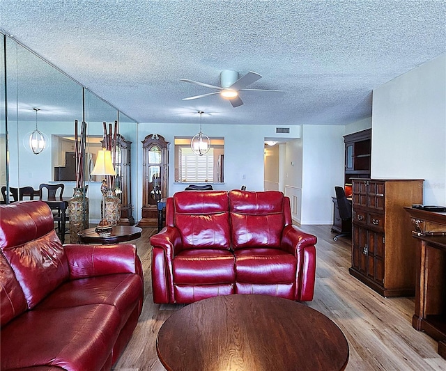 6060 Shore Blvd S Unit 903, Gulfport, FL 33707 - home theater room featuring wood finished floors, a ceiling fan, a textured ceiling, and baseboards