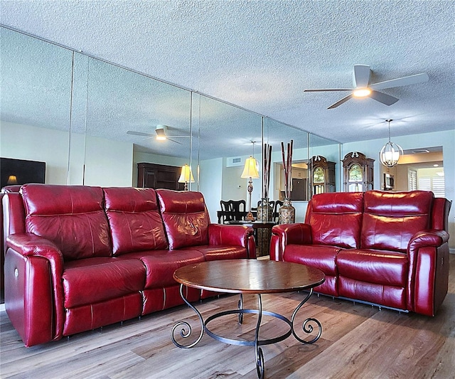 6060 Shore Blvd S Unit 903, Gulfport, FL 33707 - living room featuring ceiling fan, wood finished floors, and a textured ceiling