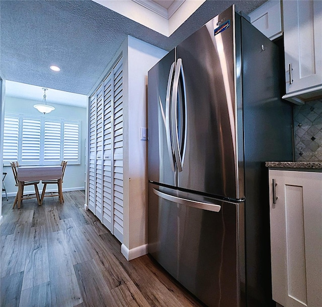 6060 Shore Blvd S Unit 903, Gulfport, FL 33707 - kitchen with freestanding refrigerator, baseboards, dark wood-style flooring, recessed lighting, and white cabinetry