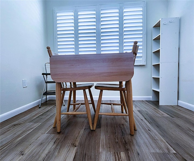 6060 Shore Blvd S Unit 903, Gulfport, FL 33707 - dining room featuring baseboards and wood finished floors