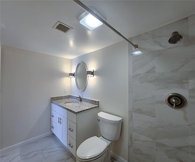 6060 Shore Blvd S Unit 903, Gulfport, FL 33707 - full bath with marble look tile flooring, a tile shower, vanity, baseboards, and toilet