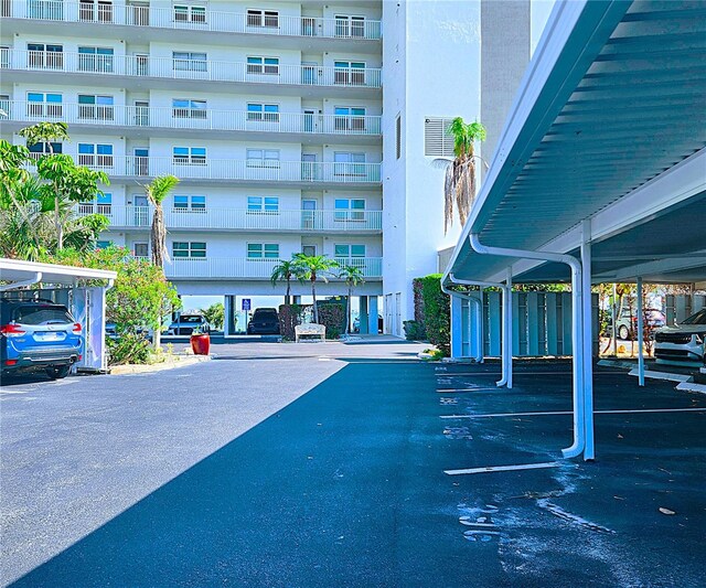 6060 Shore Blvd S Unit 903, Gulfport, FL 33707 - view of apartment building / complex featuring covered parking