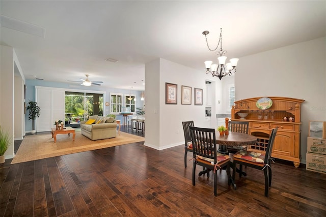 5102 Coastal Scene Dr, Apollo Beach, FL 33572 - dining area featuring a chandelier, dark wood-style flooring, ceiling fan, and baseboards