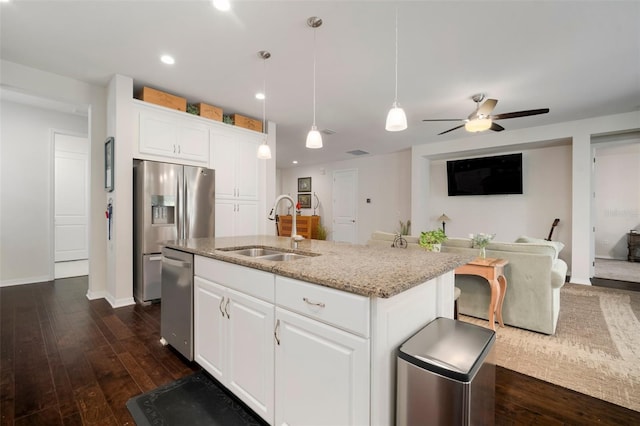 5102 Coastal Scene Dr, Apollo Beach, FL 33572 - kitchen with a sink, stainless steel appliances, light stone countertops, dark wood-style flooring, and open floor plan