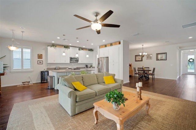 5102 Coastal Scene Dr, Apollo Beach, FL 33572 - living room with wood finished floors, ceiling fan, baseboards, recessed lighting, and a chandelier
