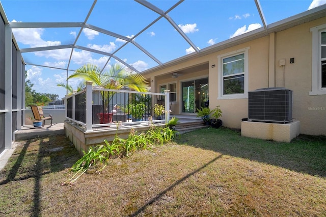 5102 Coastal Scene Dr, Apollo Beach, FL 33572 - back of property featuring cooling unit, stucco siding, a deck, a lawn, and a ceiling fan