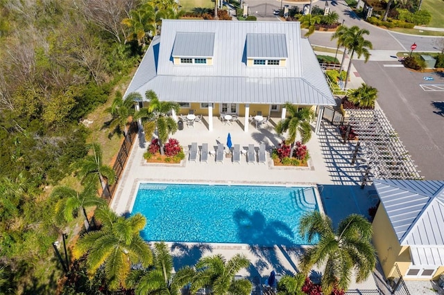 5102 Coastal Scene Dr, Apollo Beach, FL 33572 - back of property featuring a patio, a community pool, and metal roof