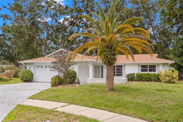 2956 Sutherland Ct, Palm Harbor, FL 34684 - view of front of house featuring concrete driveway, a garage, a front yard, and stucco siding