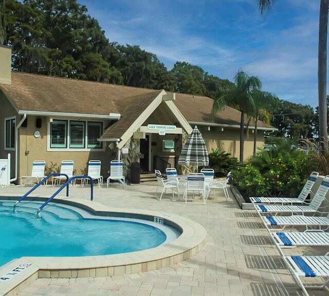 2956 Sutherland Ct, Palm Harbor, FL 34684 - community pool featuring a patio area