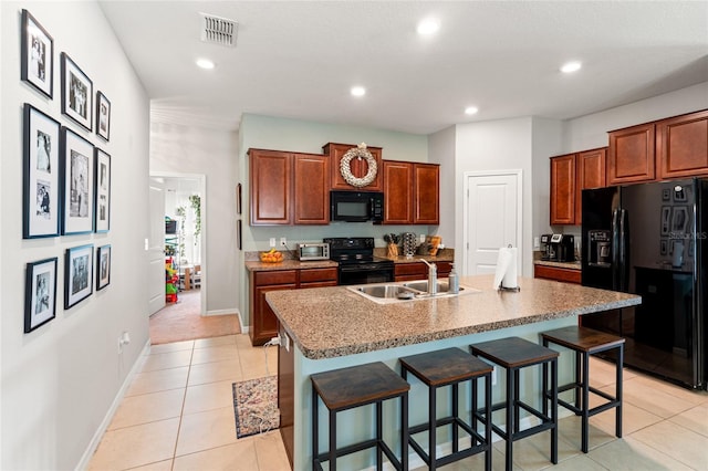 10512 Fuzzy Cattail St, Riverview, FL 33578 - kitchen with black appliances, a sink, a kitchen breakfast bar, light tile patterned flooring, and recessed lighting