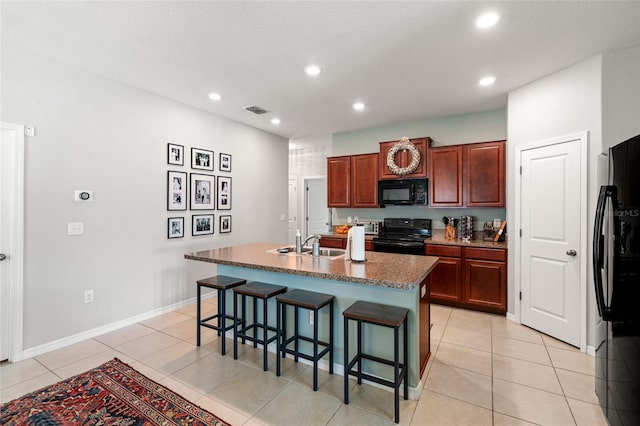 10512 Fuzzy Cattail St, Riverview, FL 33578 - kitchen with black appliances, a sink, a breakfast bar, recessed lighting, and an island with sink