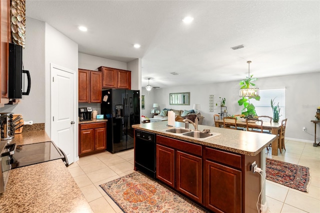10512 Fuzzy Cattail St, Riverview, FL 33578 - kitchen with black appliances, a sink, a kitchen island with sink, light tile patterned floors, and decorative light fixtures