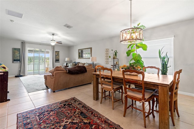 10512 Fuzzy Cattail St, Riverview, FL 33578 - dining room with a chandelier, light tile patterned floors, ceiling fan, and baseboards