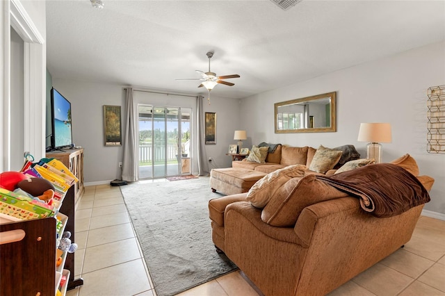 10512 Fuzzy Cattail St, Riverview, FL 33578 - living room featuring light tile patterned flooring, a ceiling fan, and baseboards