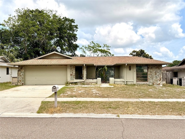 613 Sandy Hollow Rd, Tarpon Springs, FL 34689 - ranch-style home with stone siding, a garage, driveway, and central AC