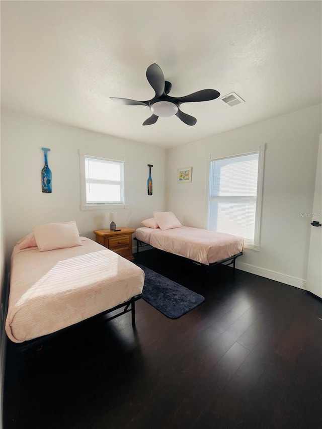 4049 Ponea Dr, Sarasota, FL 34241 - bedroom featuring dark wood-type flooring, a ceiling fan, and baseboards
