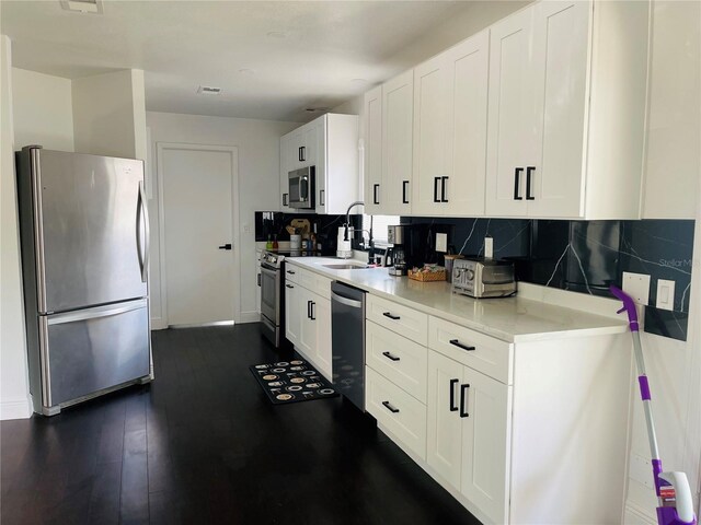 4049 Ponea Dr, Sarasota, FL 34241 - kitchen featuring stainless steel appliances, a sink, decorative backsplash, and light countertops