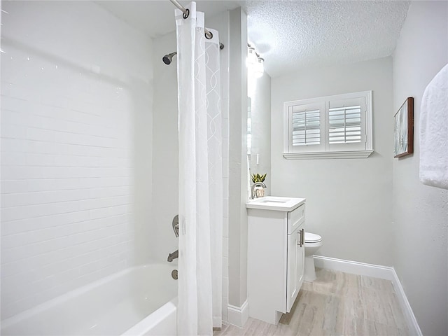 9929 Bay Dr, Gibsonton, FL 33534 - bathroom with wood finished floors, shower / tub combo with curtain, vanity, a textured ceiling, and baseboards