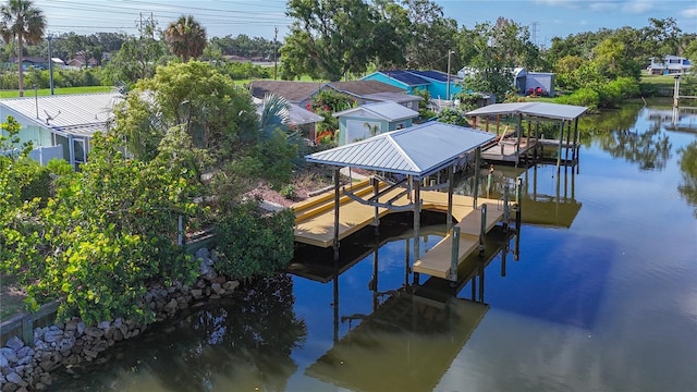 9929 Bay Dr, Gibsonton, FL 33534 - dock area featuring boat lift, a water view, and view of wooded area