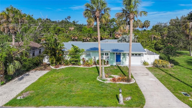 9929 Bay Dr, Gibsonton, FL 33534 - ranch-style home with concrete driveway, a garage, and metal roof