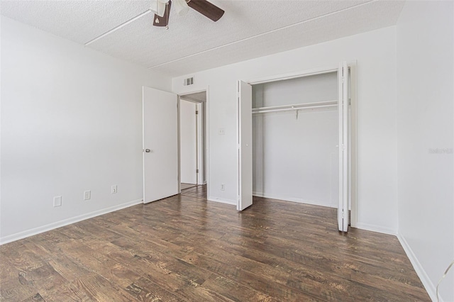 4708 Michael Ct Unit 103, Tampa, FL 33614 - unfurnished bedroom featuring wood finished floors, a textured ceiling, ceiling fan, a closet, and baseboards