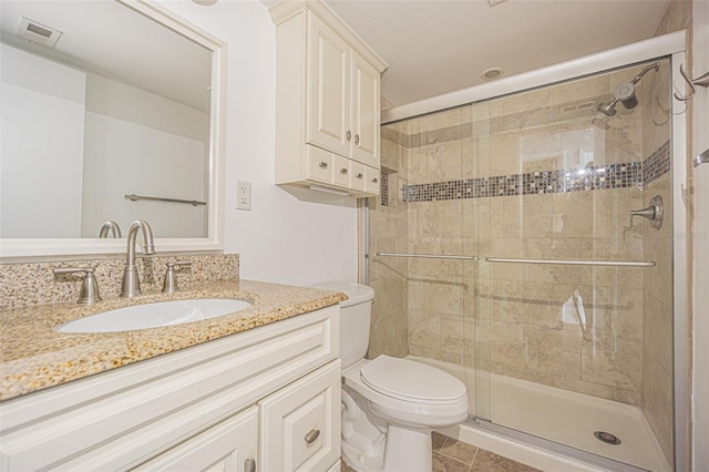 4708 Michael Ct Unit 103, Tampa, FL 33614 - full bathroom featuring vanity, a stall shower, toilet, and tile patterned floors