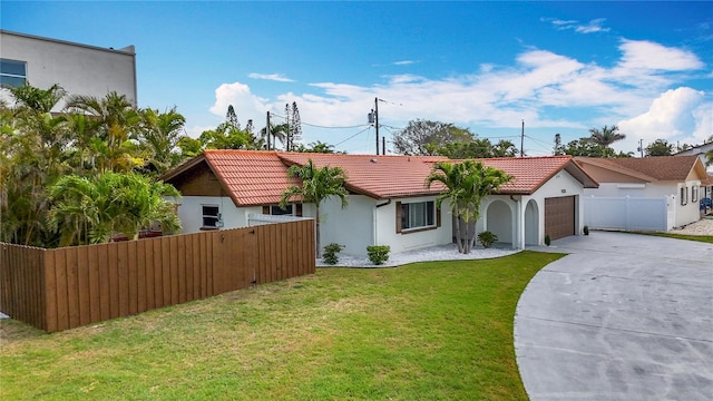 7125 S Shore Dr S, Saint Petersburg, FL 33707 - view of front facade with concrete driveway, a tile roof, stucco siding, and a garage