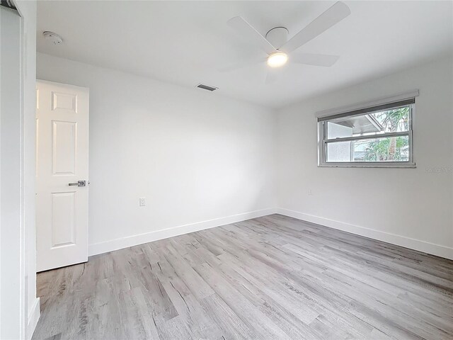 7125 S Shore Dr S, Saint Petersburg, FL 33707 - empty room with wood finished floors, a ceiling fan, a smoke detector, and baseboards