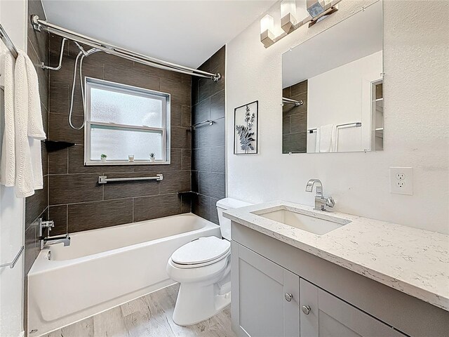 7125 S Shore Dr S, Saint Petersburg, FL 33707 - full bath with shower / bath combination, vanity, toilet, and wood finished floors