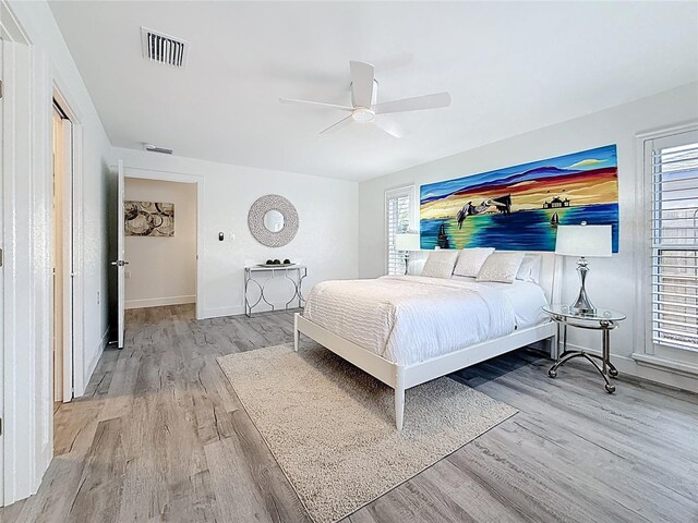7125 S Shore Dr S, Saint Petersburg, FL 33707 - bedroom featuring wood finished floors, baseboards, and ceiling fan