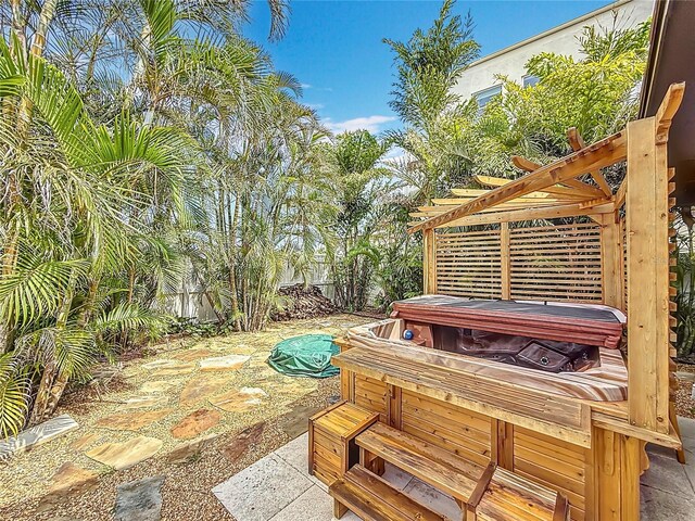 7125 S Shore Dr S, Saint Petersburg, FL 33707 - wooden terrace with a hot tub and a patio area