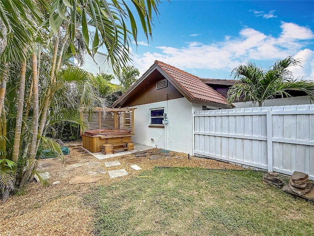 7125 S Shore Dr S, Saint Petersburg, FL 33707 - view of property exterior featuring a hot tub, a tiled roof, and stucco siding