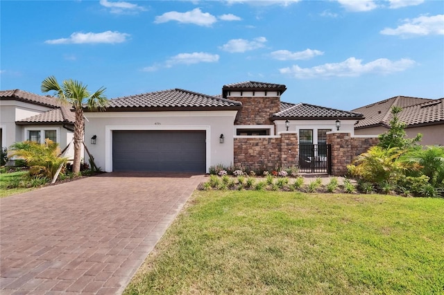 4795 Freccia Loop, Wesley Chapel, FL 33543 - mediterranean / spanish home with stone siding, stucco siding, a garage, and driveway
