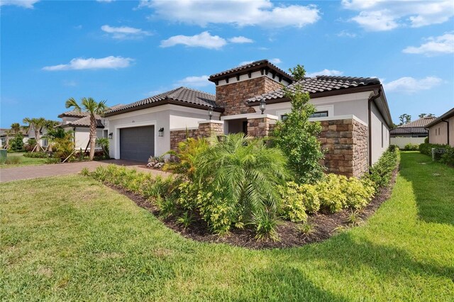 4795 Freccia Loop, Wesley Chapel, FL 33543 - view of front facade featuring stone siding, stucco siding, driveway, and a front yard