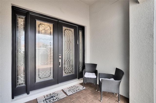 4795 Freccia Loop, Wesley Chapel, FL 33543 - doorway to property featuring french doors and stucco siding
