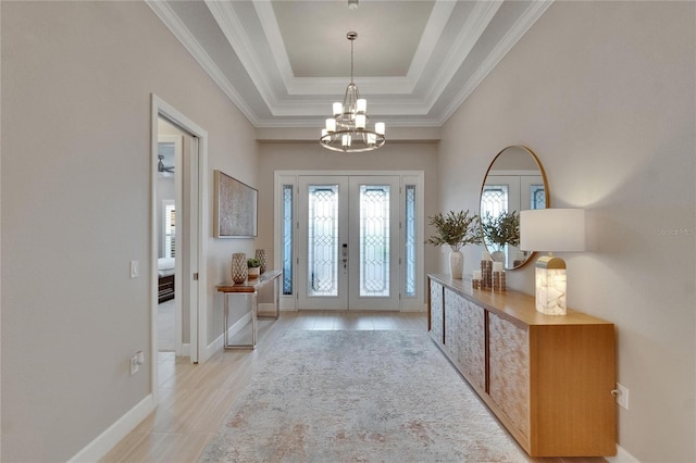 4795 Freccia Loop, Wesley Chapel, FL 33543 - foyer with french doors, a chandelier, a raised ceiling, baseboards, and ornamental molding