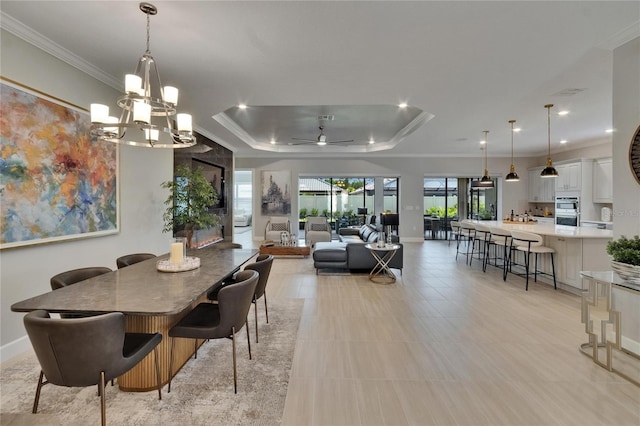 4795 Freccia Loop, Wesley Chapel, FL 33543 - dining room with a raised ceiling, ornamental molding, a chandelier, baseboards, and recessed lighting