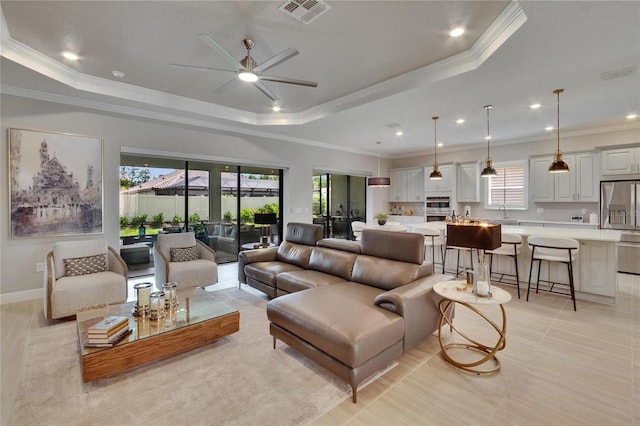 4795 Freccia Loop, Wesley Chapel, FL 33543 - living area featuring a raised ceiling, healthy amount of natural light, a ceiling fan, crown molding, and recessed lighting