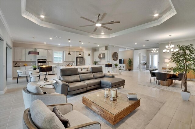 4795 Freccia Loop, Wesley Chapel, FL 33543 - living area featuring a raised ceiling, a ceiling fan, crown molding, a chandelier, and light tile patterned flooring