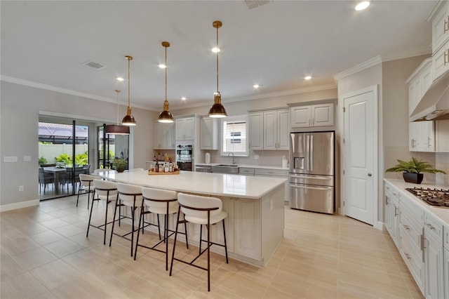 4795 Freccia Loop, Wesley Chapel, FL 33543 - kitchen with stainless steel appliances, a sink, a large island, decorative backsplash, and a breakfast bar area