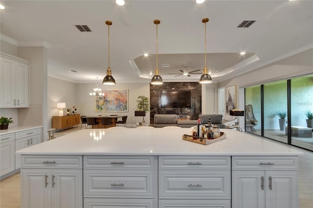 4795 Freccia Loop, Wesley Chapel, FL 33543 - kitchen with a ceiling fan, ornamental molding, white cabinets, open floor plan, and light countertops