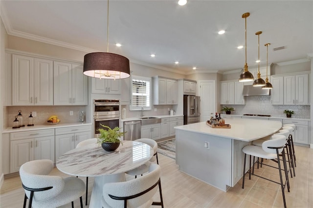 4795 Freccia Loop, Wesley Chapel, FL 33543 - kitchen featuring stainless steel appliances, a kitchen breakfast bar, tasteful backsplash, recessed lighting, and a kitchen island