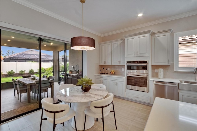 4795 Freccia Loop, Wesley Chapel, FL 33543 - dining room with healthy amount of natural light, crown molding, and light tile patterned flooring