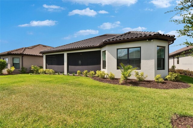 4795 Freccia Loop, Wesley Chapel, FL 33543 - view of property exterior with a lawn, a tile roof, and stucco siding