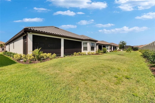 4795 Freccia Loop, Wesley Chapel, FL 33543 - rear view of property featuring a lawn, a tile roof, and stucco siding
