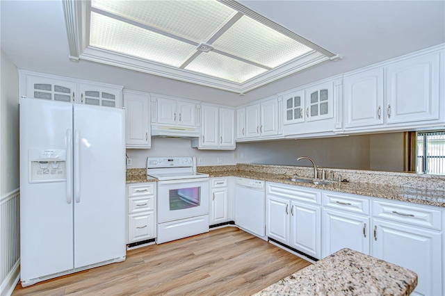 6550 Teak Ct, Zephyrhills, FL 33542 - kitchen with white appliances, glass insert cabinets, a sink, and white cabinetry