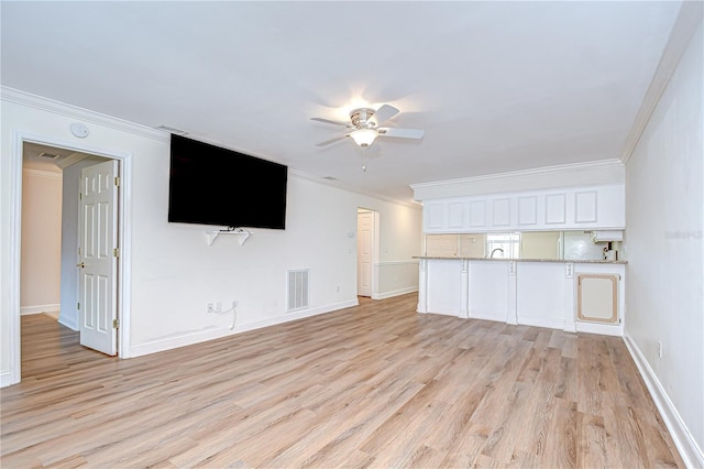 6550 Teak Ct, Zephyrhills, FL 33542 - unfurnished living room with ceiling fan, light wood-style flooring, crown molding, and baseboards